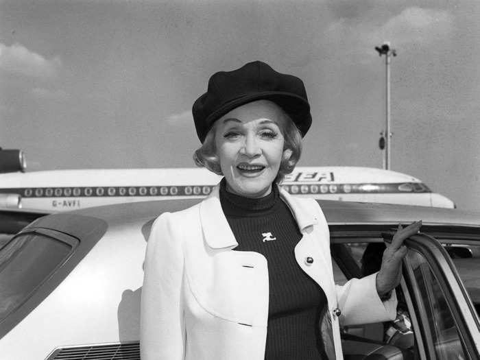 German American actress and singer Marlene Dietrich wore a crisp, light-colored coat as she arrived at Heathrow Airport from Paris in 1971.