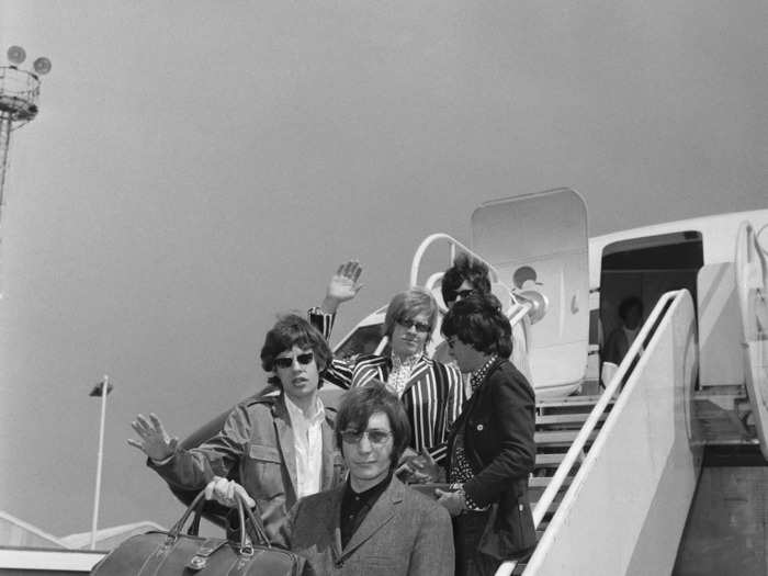 Taken four years after they formed, a photo shows The Rolling Stones leaving London on a flight to New York in 1966.