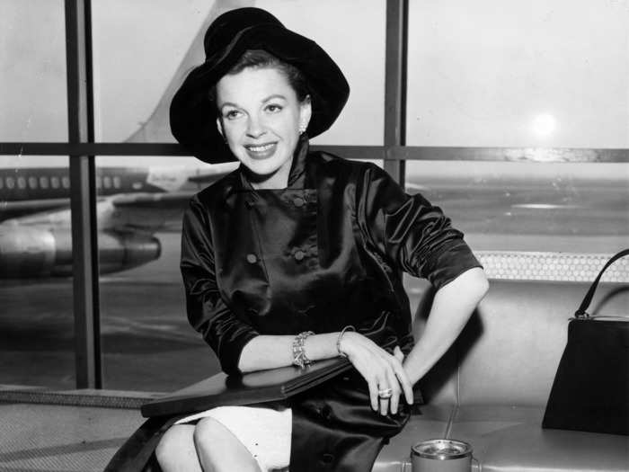 A year after the release of "A Star Is Born," Judy Garland posed in a chic, all-black ensemble at an airport in 1955.
