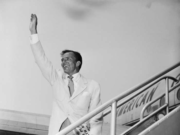 Frank Sinatra waved goodbye to fans as he boarded a flight for London at Idlewild Airport — now John F. Kennedy International Airport — in New York in 1950.