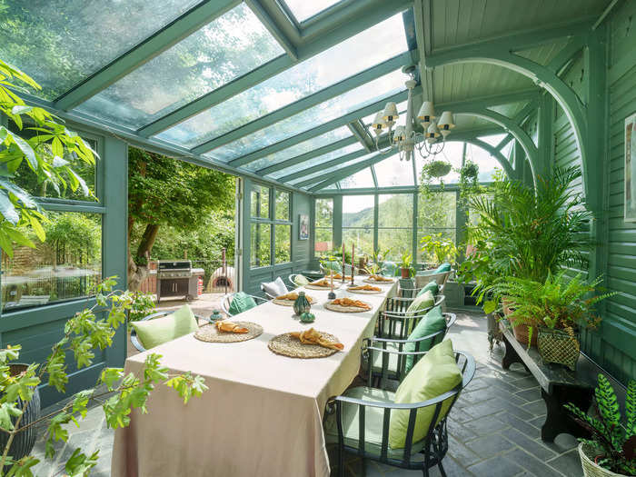 The current owner purchased the house in 2002 and renovated the property, adding this colourful conservatory dining room.