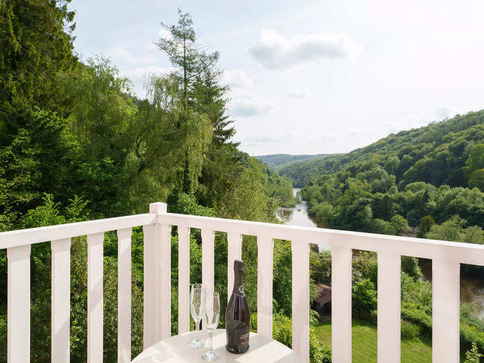 The balcony extends over both sides of the property, offering views of the local river.