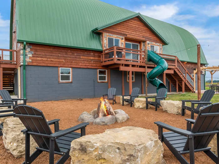 Outside, there is a tube slide that leads from the second-floor deck to the campfire area in the backyard.