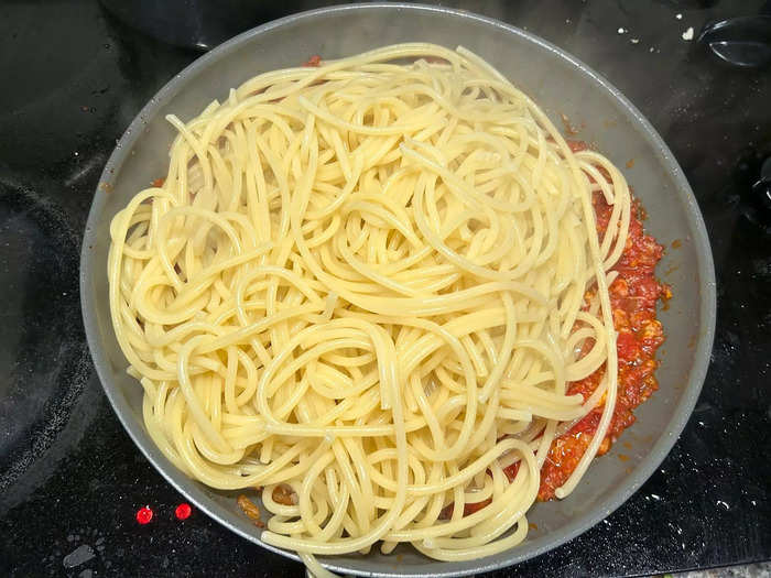 Once my pasta was ready, I drained the noodles and added them into the sauce.