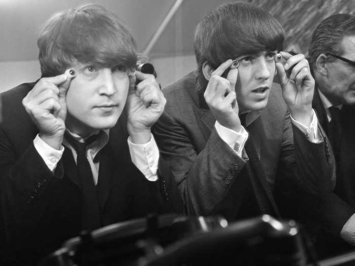 John Lennon and George Harrison were photographed trying to pick the perfect eyes for their wax counterparts in 1964.