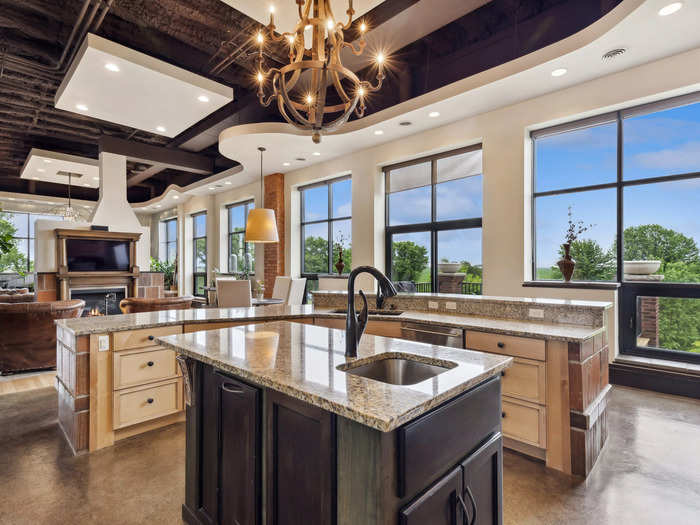 In the main living space, floor-to-ceiling windows showcase views of the rural Iowa countryside.