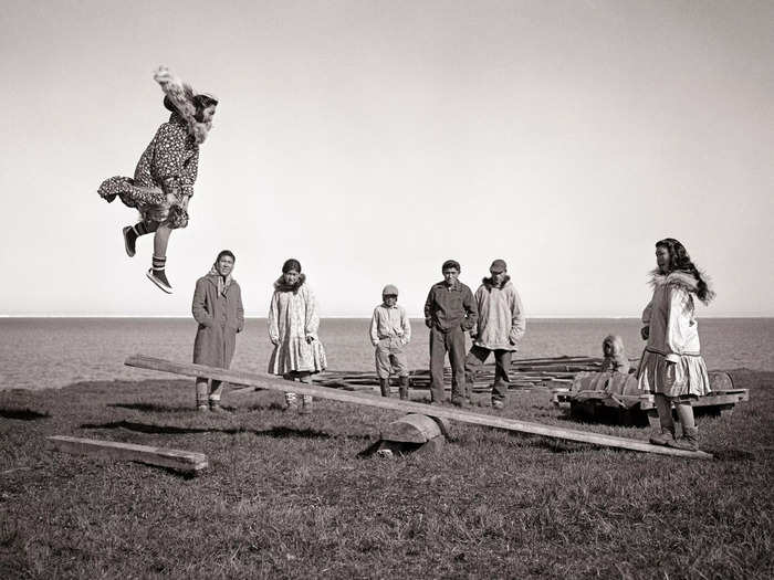 1949: A group of Alaskan teenagers play what looks like an extreme version of a seesaw.