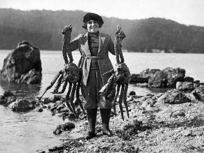 1926: Photographer Frank Kleinschmidt and his family moved to Alaska during the gold rush. This is his wife holding two huge Alaskan king crabs.