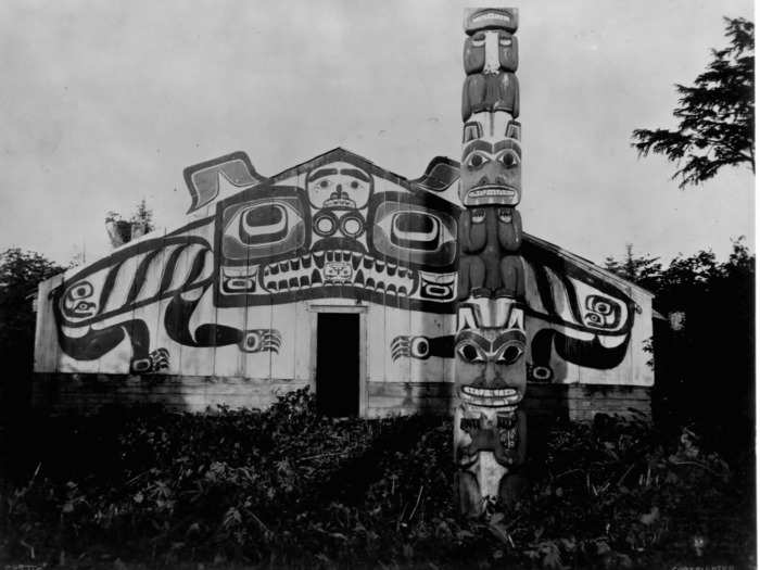 1899: Totem poles like this one, seen outside an Alaskan lodge, tell the story of the family or tribe that constructed the pole.