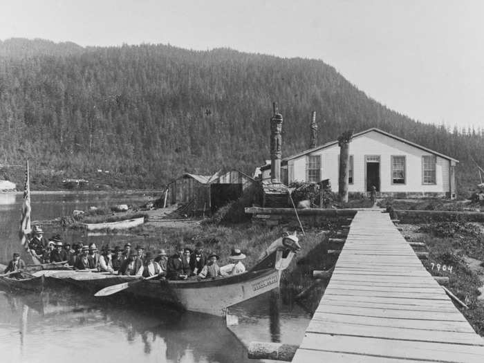 1890: A canoe called Brown Bear carries a funeral party to docks at Wrangell Island.