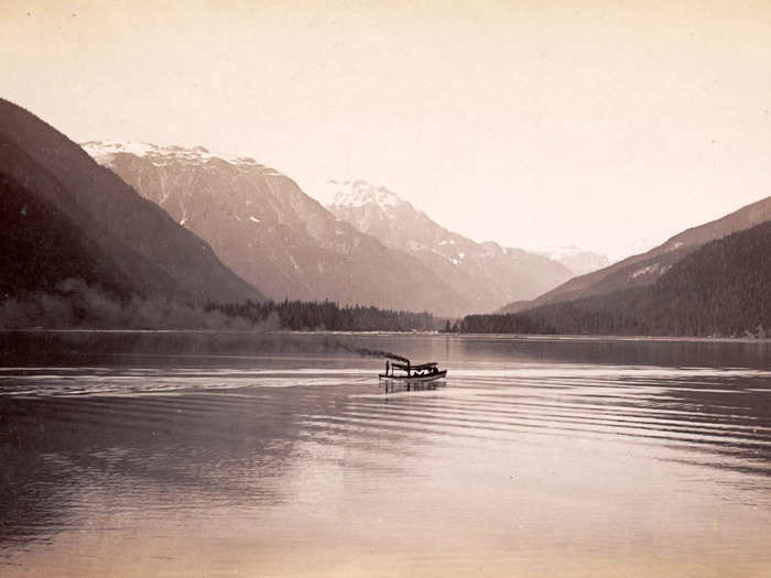 1887: A ship sails the Salmon River under the watchful eyes of the mountaintops.