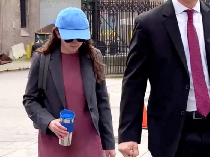 On her way into the courtroom, Ellison sported sunglasses and an unbranded blue hat.