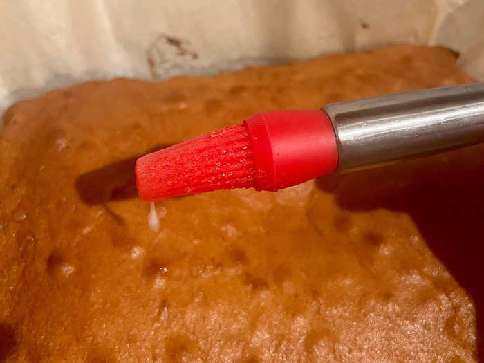 After 35 minutes, the tray bake was ready. I carefully transferred it onto a serving dish to cool for five minutes before brushing it with a heavy layer of the glaze.