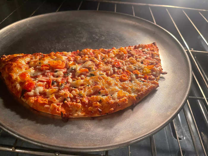 The pizza began to turn a nice golden-brown color in the oven.