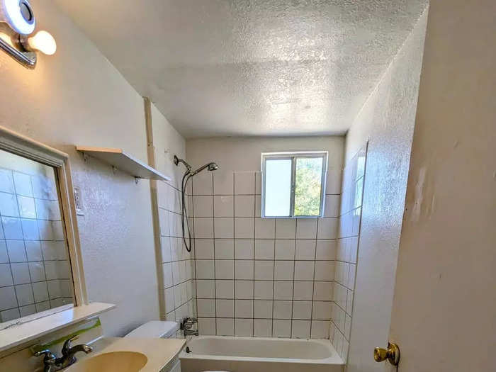 The bathroom includes a window in the shower, which is also tiled.