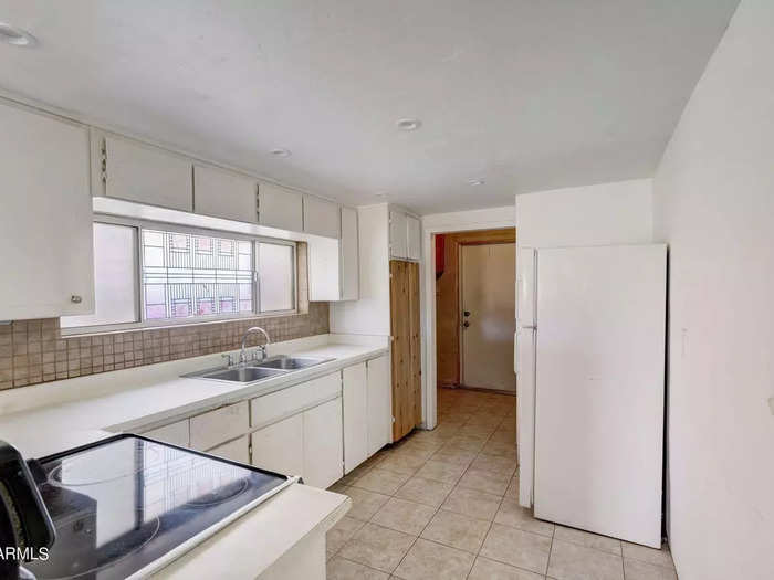 This kitchen comes with laminate countertops and a window above the sink.