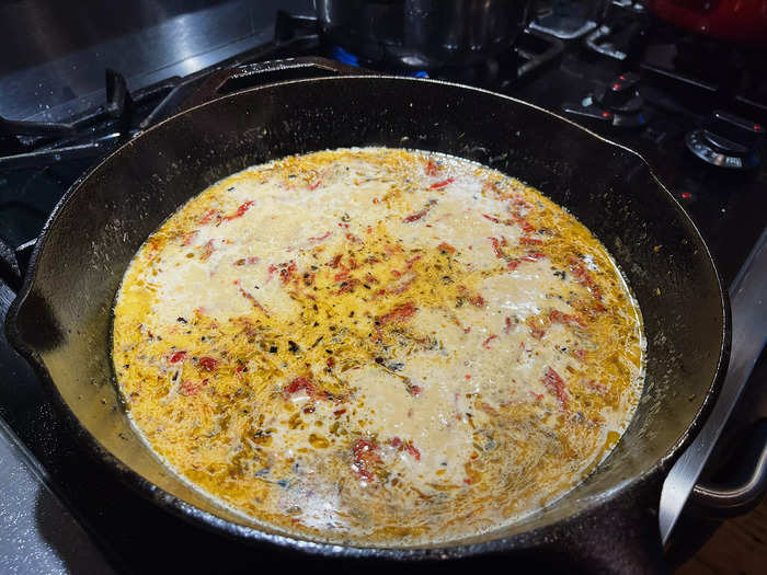 Then I added in a half-cup of heavy cream, a cup of chicken broth, a half-cup of chopped sun-dried tomatoes, and a quarter-cup of Parmesan cheese.