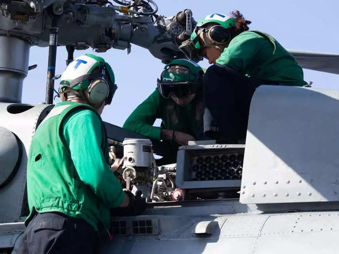 Maintenance can include checking the rotor assembly of a helicopter.