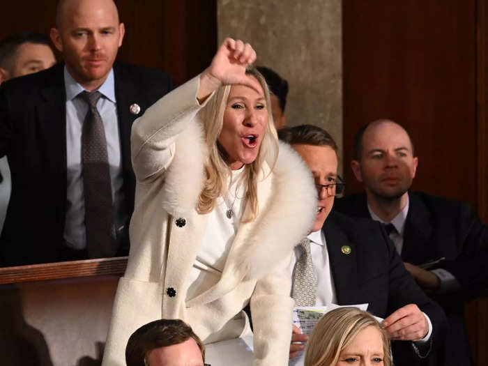 As Biden delivered the 2023 State of the Union address, Greene rose from her seat and gave a thumbs-down gesture.