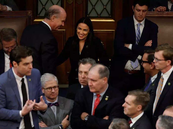 Rep. Alexandria Ocasio-Cortez was photographed smiling in the background as Republican lawmakers argued during the second day of the proceedings.