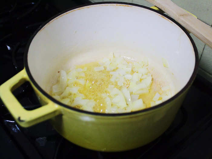 After the butter had fully melted, I added the yellow onion to the pot and gave it a good stir. The delicious smell of butter and onions quickly filled my kitchen.