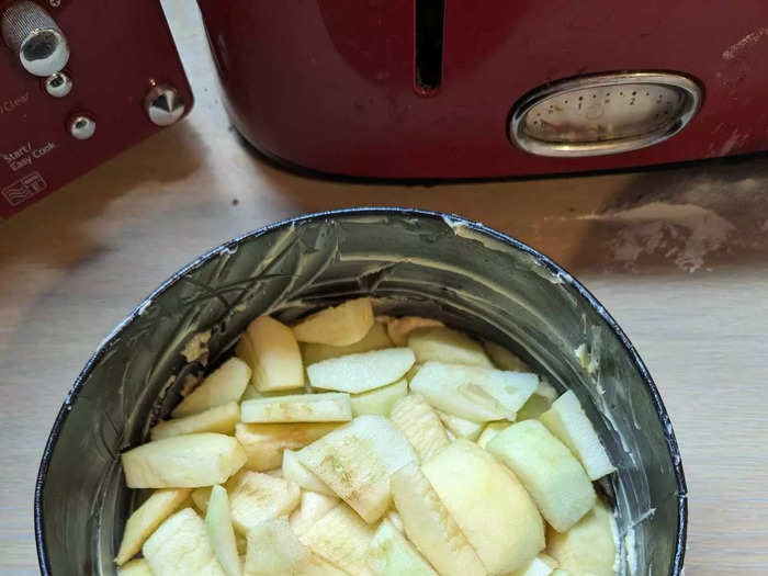 After adding half of the mix to the baking tray, I added thickly-sliced apples.