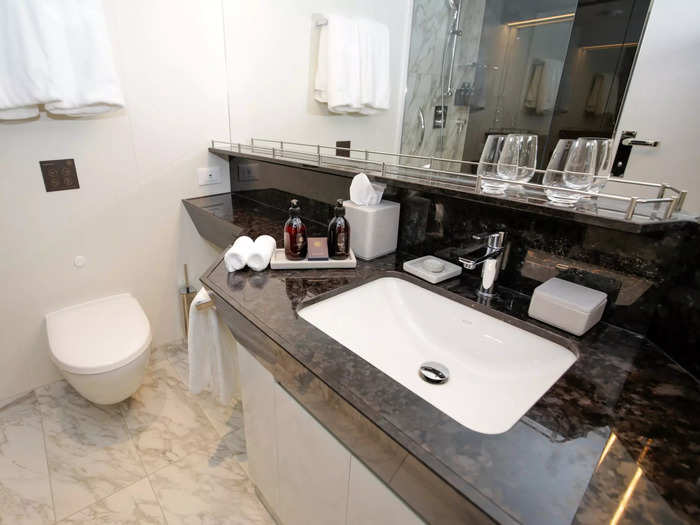 But size aside, the little details in this room — specifically the dark marbled countertop and towel hangers inside the shower — inched ahead of Oceania.