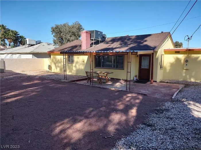 The home has a large outdoor space with a covered patio area, yard, and shed.