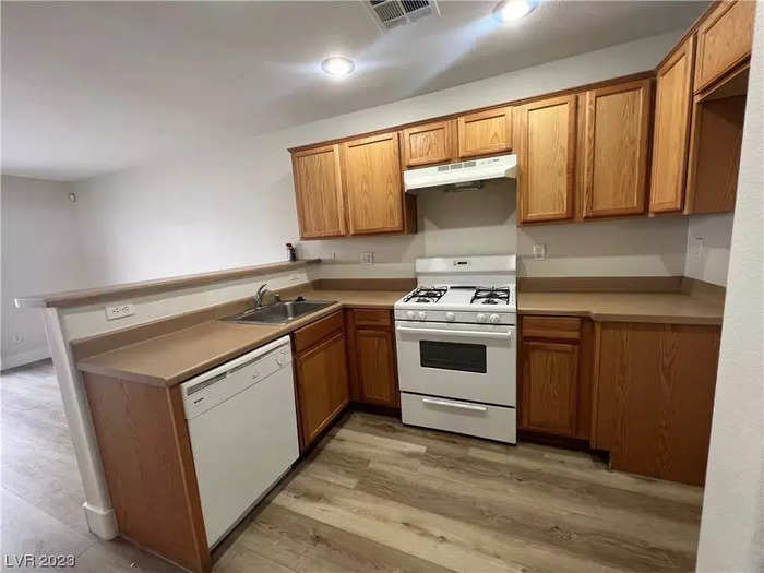 The kitchen is separated from a living or dining space by a half wall.