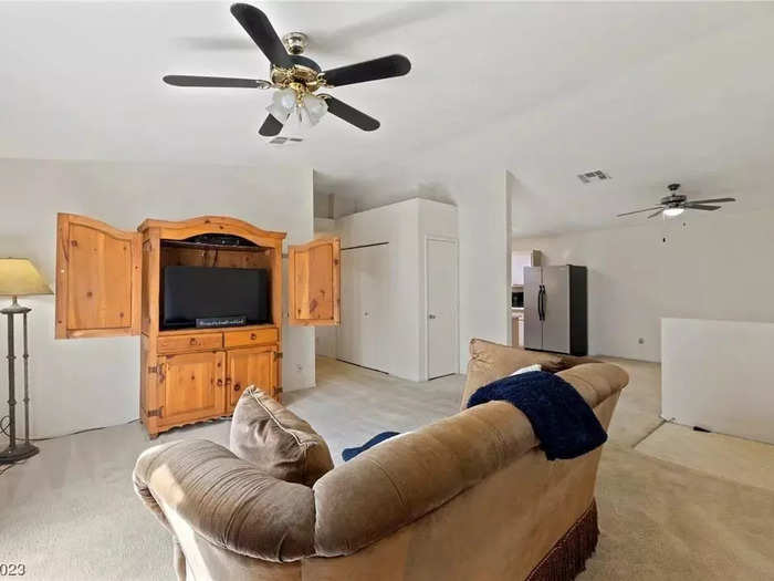 The entry area connects to the living room, which has lots of natural light.