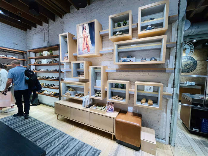 Towards the back of the store, there are more walls of shoes and an area to try them on