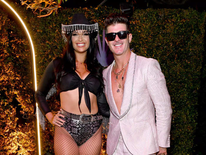 April Love Geary wore a cowgirl costume, while her partner, Robin Thicke, opted for a silver suit with no shirt.