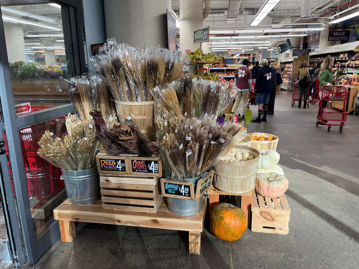 Immediately upon walking inside, I encountered fall-themed decor with rustic floral arrangements and gourds in wooden barrels.