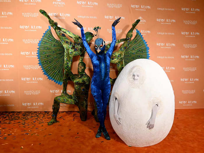 Heidi Klum dressed as a giant peacock while her husband, Tom Kaulitz, went as a peacock egg.