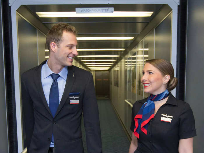 Currently, American Airlines flight attendants wear simple black dresses or suits with red and blue accents.