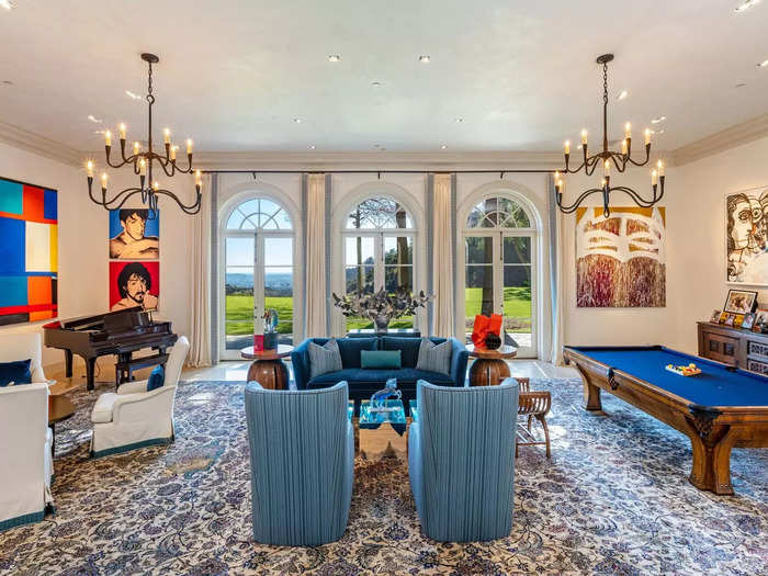 According to Hilton, while Stallone owned it, the Mediterranean-style home had eight bedrooms, 12 bathrooms, and a massive living room with a pool table, "Rocky" pop art, and floor-to-ceiling windows.