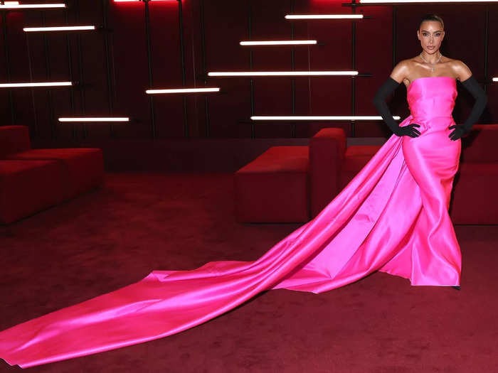 Kim Kardashian wore a bright-pink gown with a statement train to the gala.