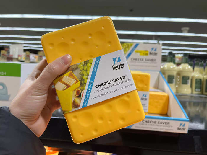 I enjoy spotting unique kitchen gadgets, like a cheese-shaped cheese container, amid the grocery items.