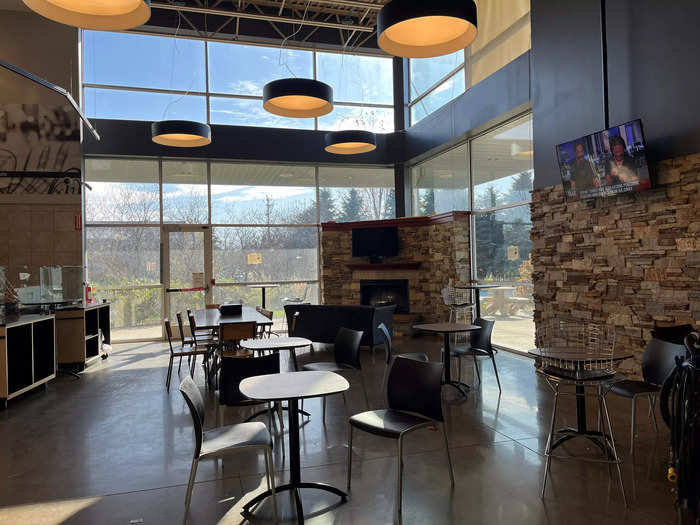 The dining area at my local Wisconsin Metro Market is furnished with a stone fireplace and large windows that bathe the area in sunlight.