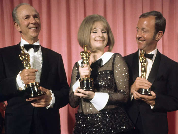 Streisand says she struggled to choose between two outfits: "a long black Empire-style gown" and a "black net" pantsuit.