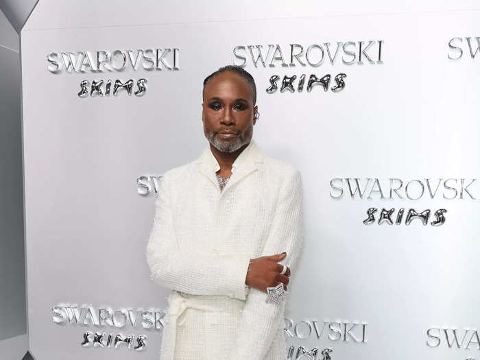 Billy Porter wore a white coat over a pair of baggy pants.