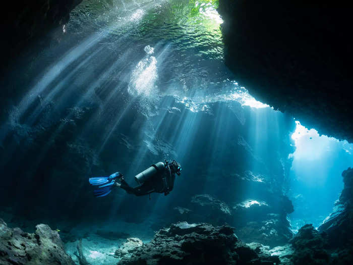 Underwater cave diving can be risky due in part to a lack of natural light. 