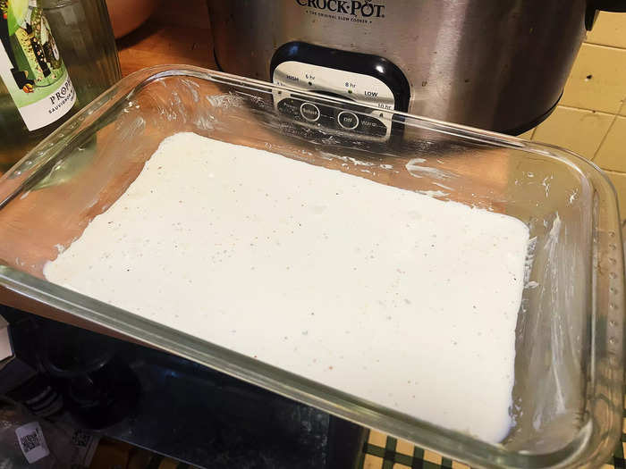 I started assembling the scalloped potatoes by pouring a third of the milk mixture into the bottom of the pan.