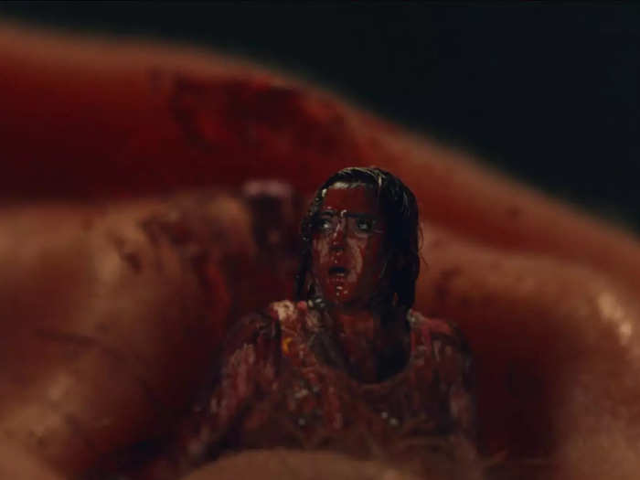 At the end of episode three, tiny Emma gets covered in blood after crawling through the ear of a guard at The Woods.