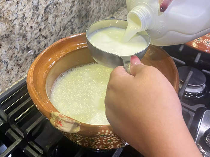 First, pour water or milk into a pot on the stove. Either works, but my abuela prefers milk for a thicker mixture.