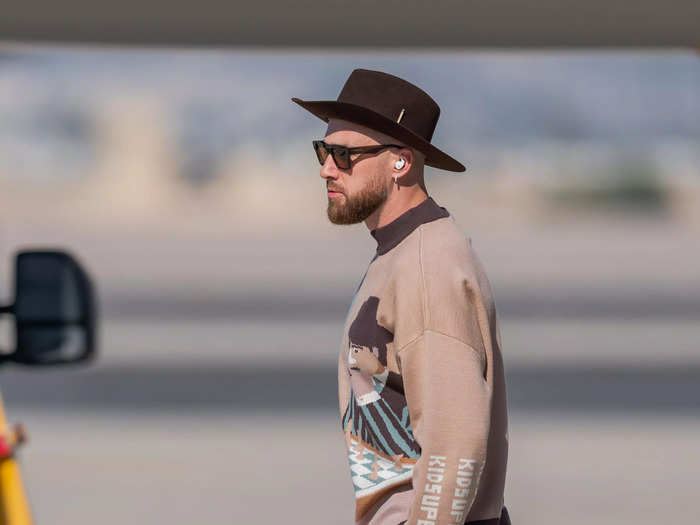 Kelce was dressed to win when he touched down for the 2023 Super Bowl in a cozy all-brown ensemble. 