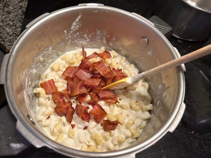 I added the cooked cavatappi to the pot, as well as the chopped bacon. 