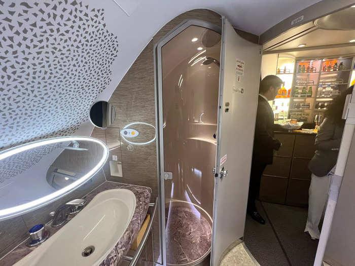 Past a food and drink station towards the front of the cabin is the spa, with its onboard shower — a feature only offered by Emirates and Etihad.