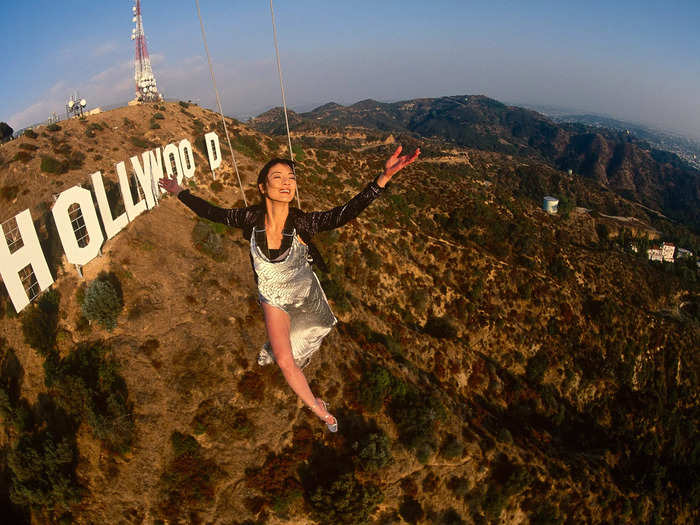 While shooting for a National Geographic cover story in 1997, Michelle Yeoh performed a daring stunt dangling from a helicopter over the Hollywood sign.