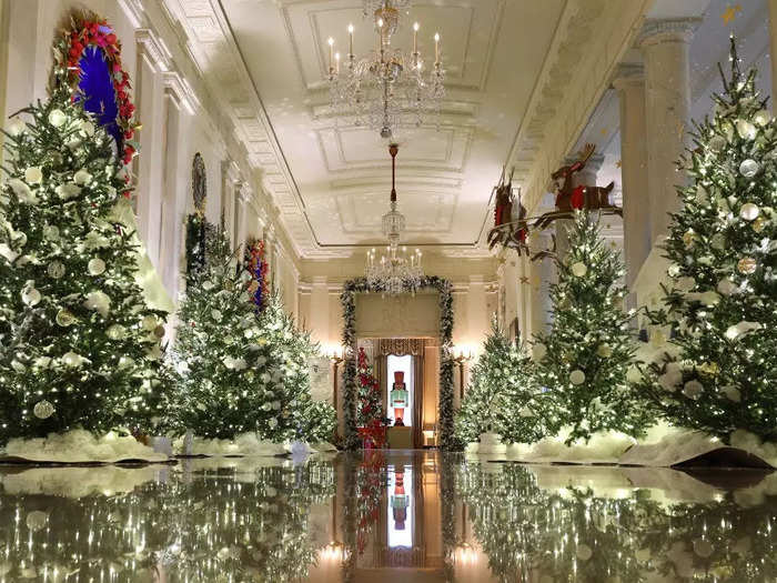 The Cross Hall is lined with glowing Christmas trees, and it also houses the official White House menorah.
